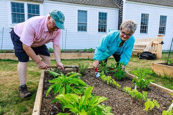 A couple works on the garden at the York Land Trust Headquarters property in York, Maine.